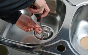 Plumber repairing kitchen sink